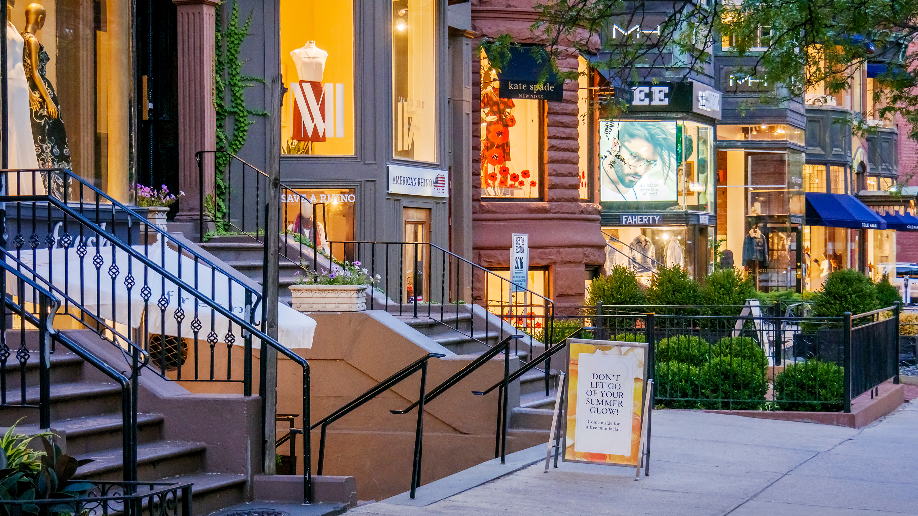 Storefronts along Newbury Street at dusk